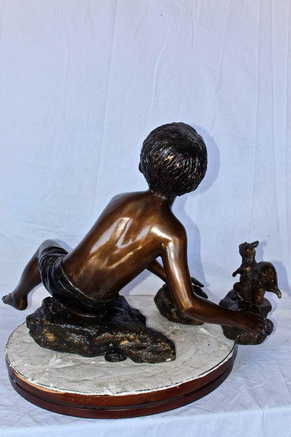 Adventurous boy with squirrel bronze statue -  Size: 36"L x 18"W x 22"H.