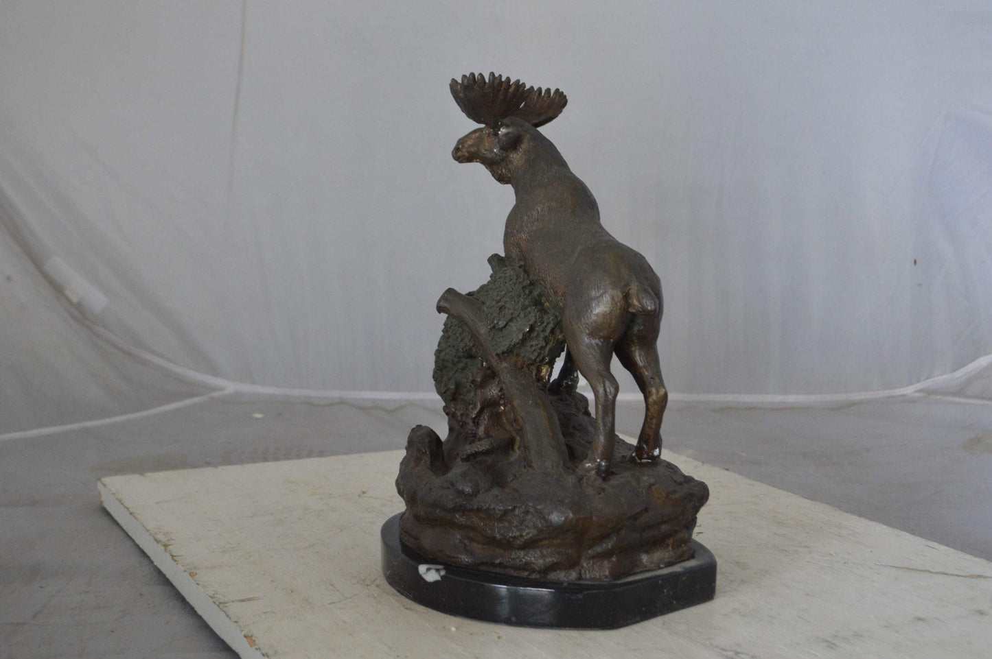 Moose on a rock bronze statue - Size: 9"L x 7"W x 14"H.