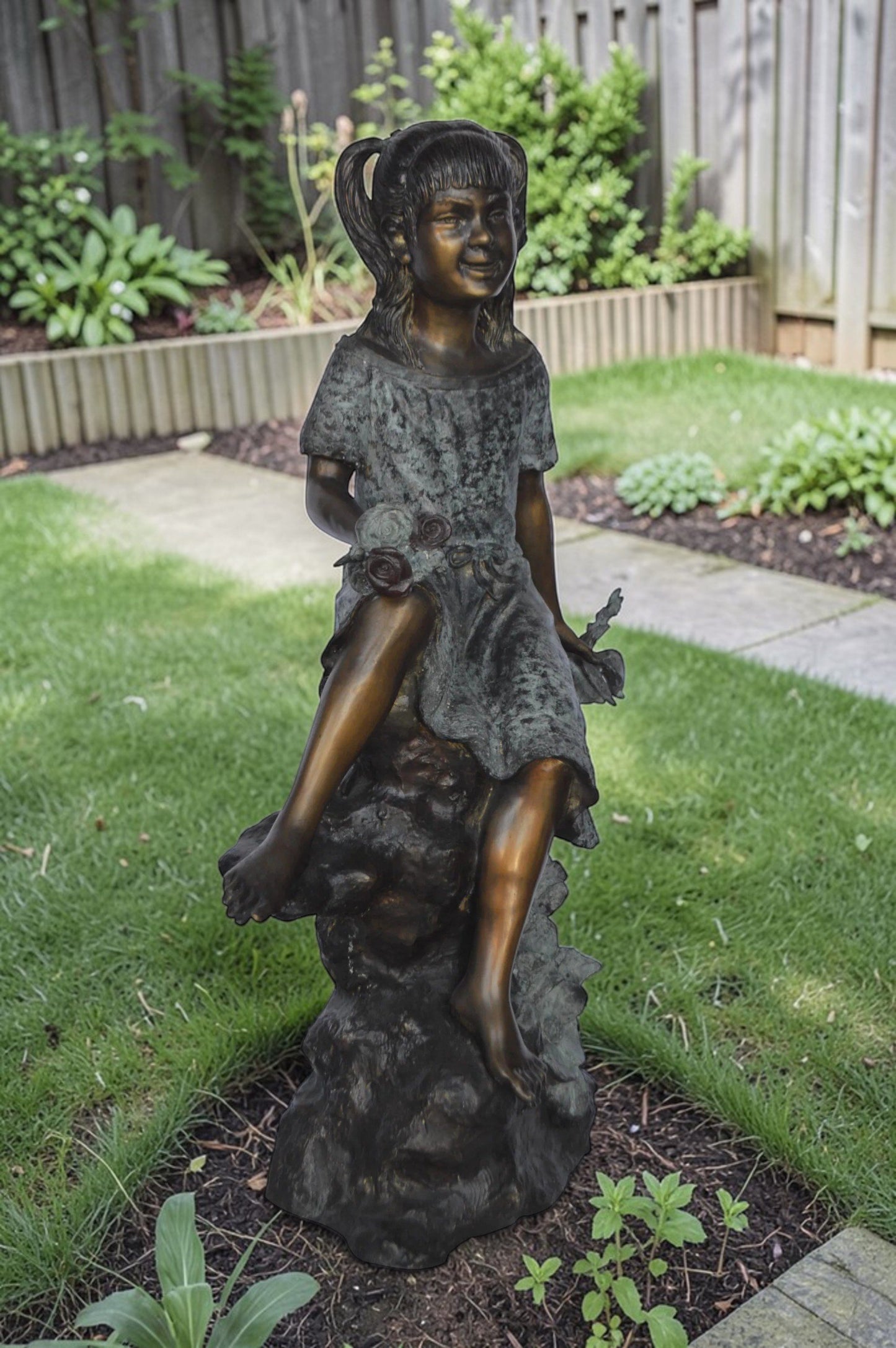 Girl on Tree  Trunk Holding Flowers Bronze Statue -  Size: 26"L x 11"W x 36"H.