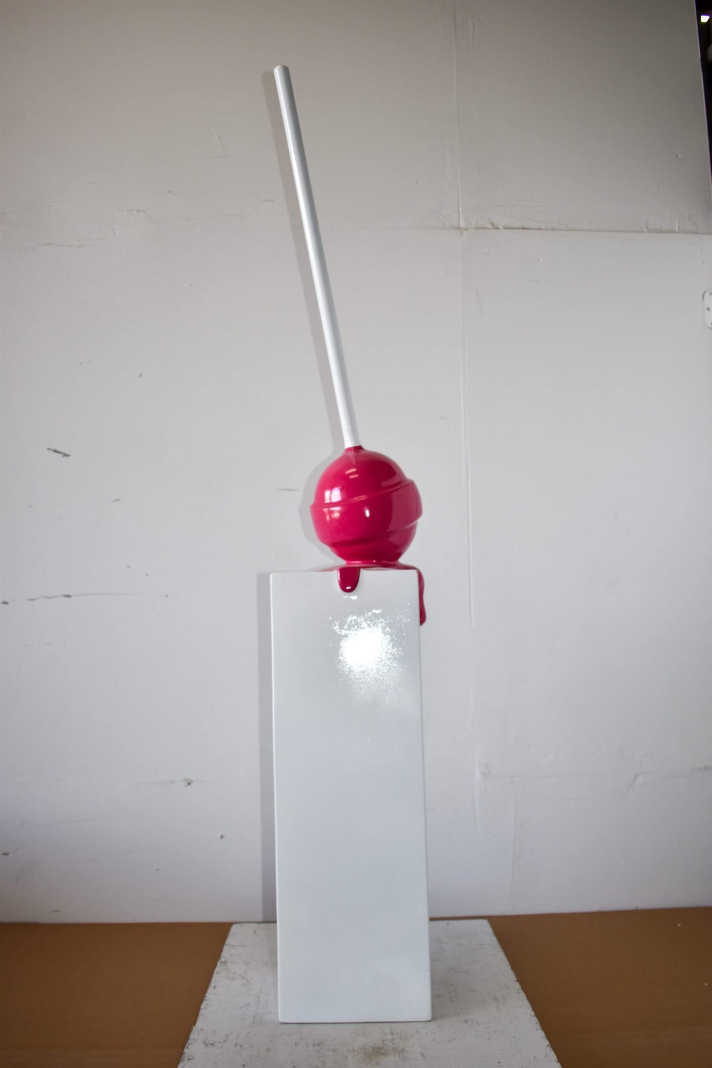 Red Lollipop Mounted on A White Pedestal Resin Statue Size: 10" x 10" x 59"H