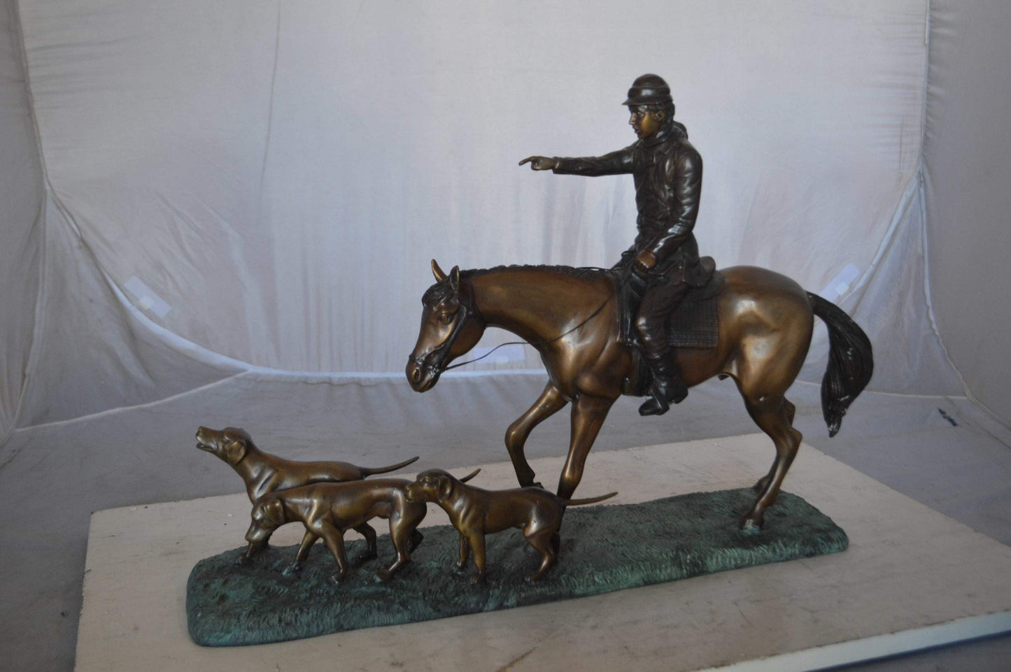 Hunter with three dogs Bronze Statue -  Size: 27"L x 6"W x 18"H.