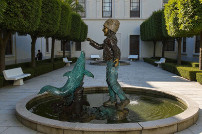Girl feeding a dolphin and seals bronze fountain -  Size: 28"L x 17"W x 37"H.