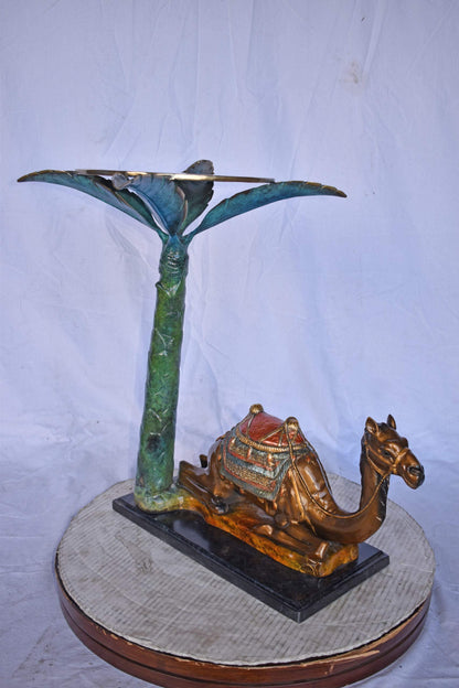 Camel Sitting Under A Palm Tree Bronze Statue - Size: 17"L x 27"W x 23"H.