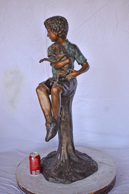 Boy Sitting on A Log with His Puppy Bronze Statue - Size: 15"L x 15"W x 35"H.