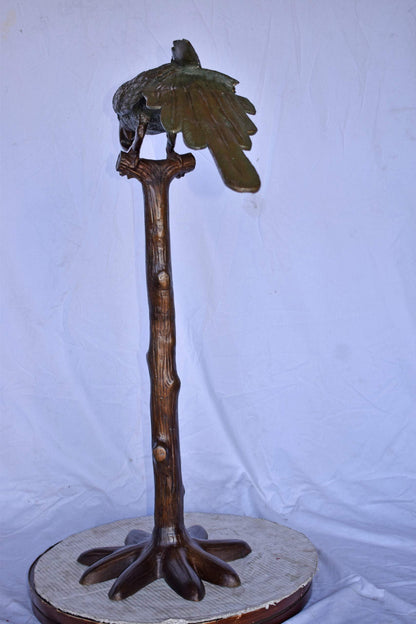 Parrot on a Tree Watching Forward Bronze Statue - Size: 36"L x 15"W x 41"H.