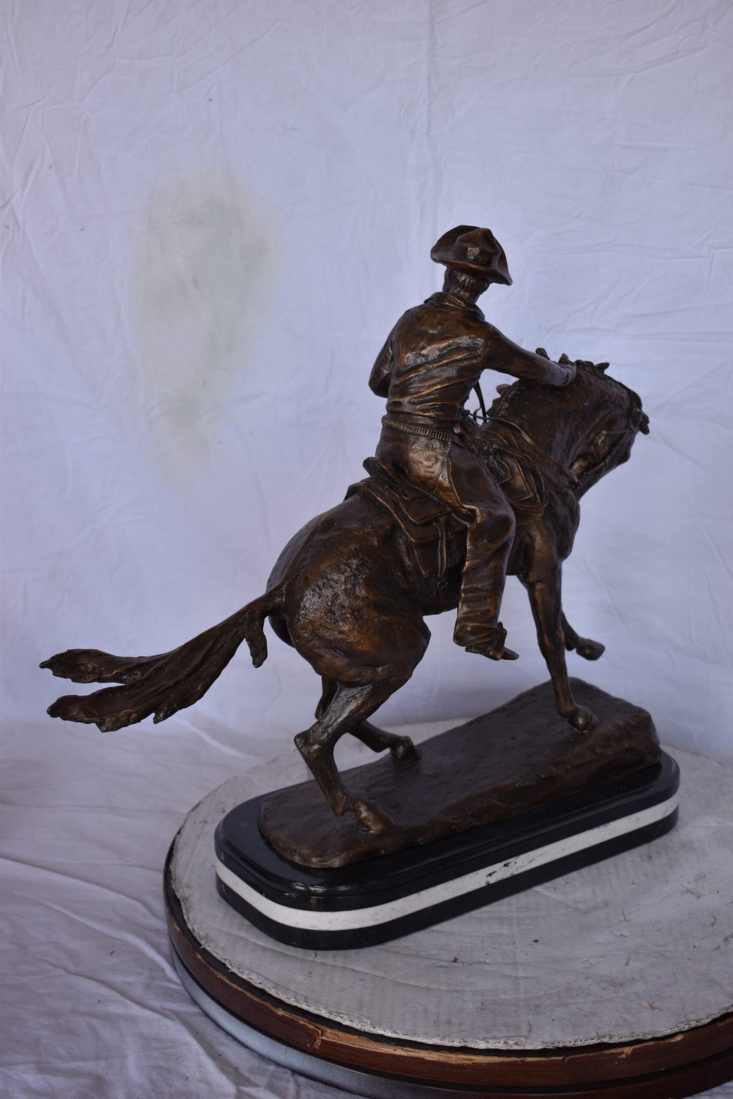 Remington Cowboy Replica Bronze Statue on Triple Marble - Size: 8"x 26"x 23"H.