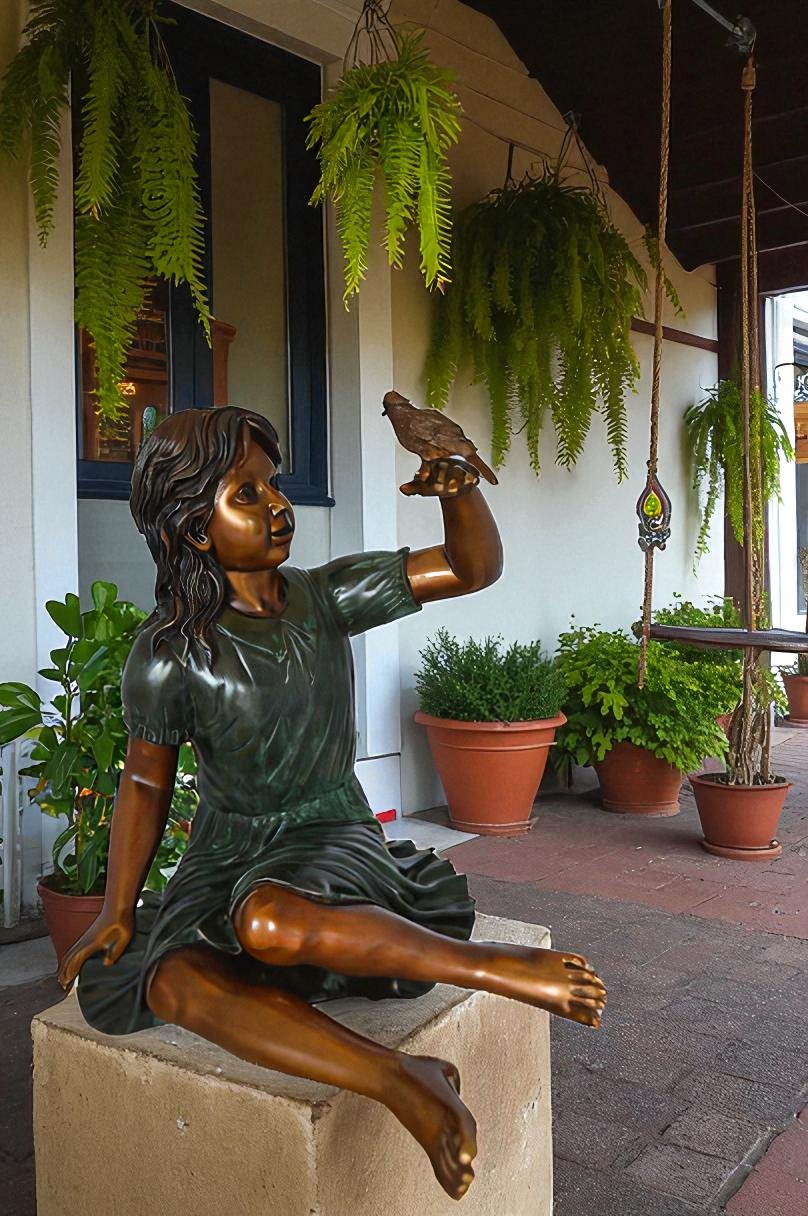 Girl with a Sparrow Bronze Statue -  Size: 24"L x 30"W x 25"H.