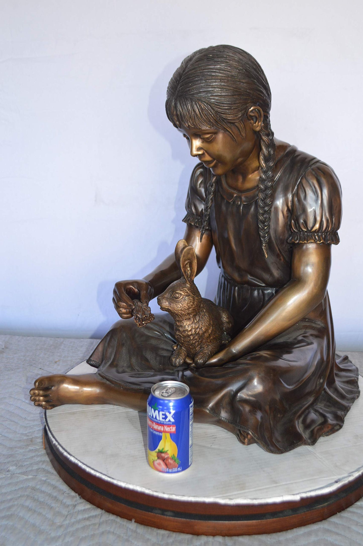 Sandra Sitting With Her Rabbit Bronze Statue -  Size: 25"L x 18"W x 25"H.