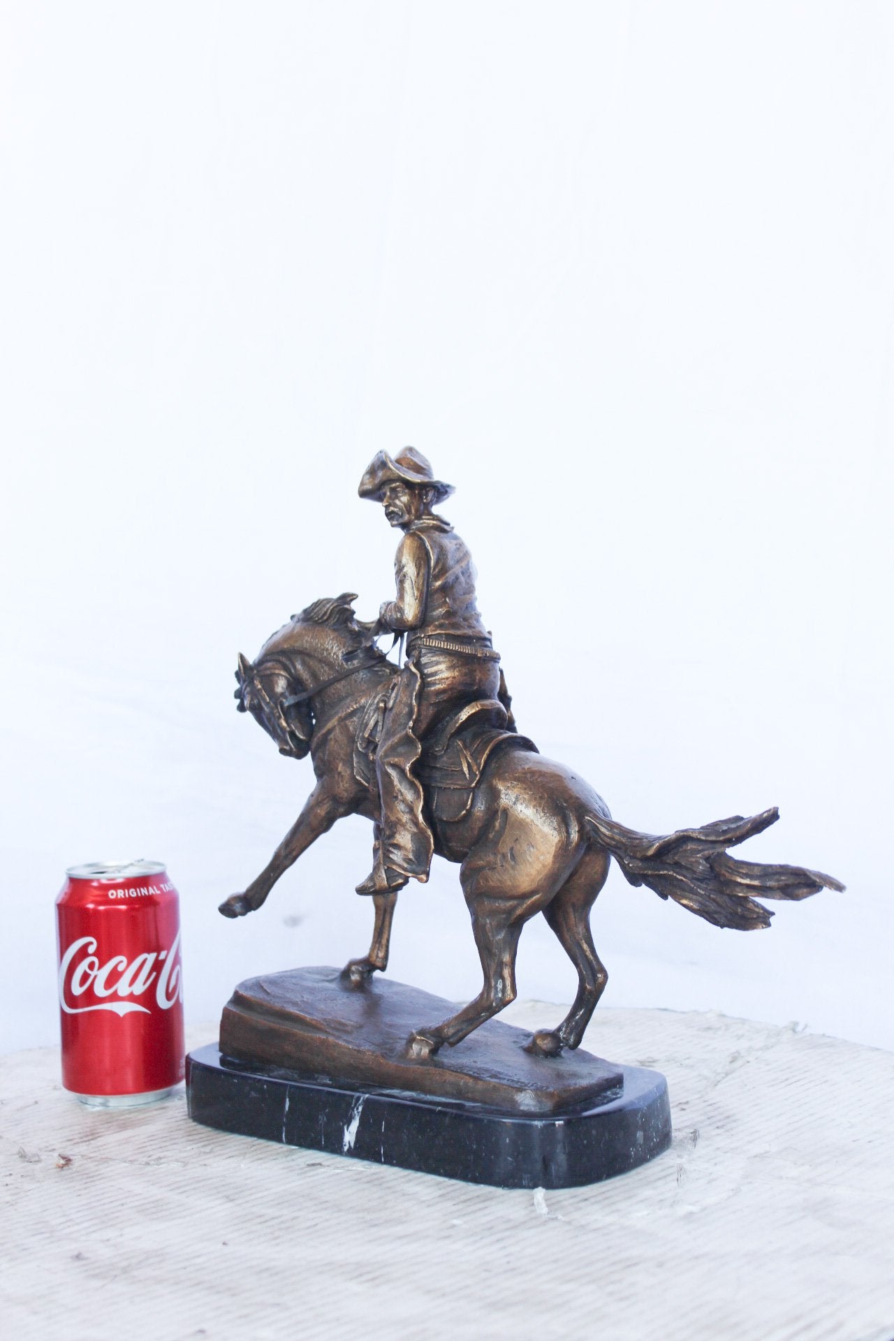 Remington replica Cowboy bronze statue -  Size: 5"L x 15"W x 13"H.