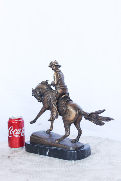 Remington replica Cowboy bronze statue -  Size: 5"L x 15"W x 13"H.