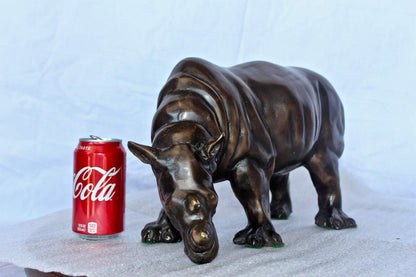 Relaxed Rhino bronze statue -  Size: 16"L x 9"W x 8"H.
