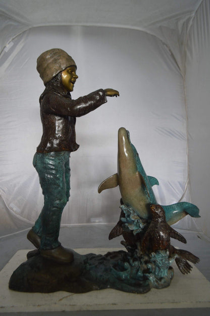 Girl feeding a dolphin and seals bronze fountain -  Size: 28"L x 17"W x 37"H.