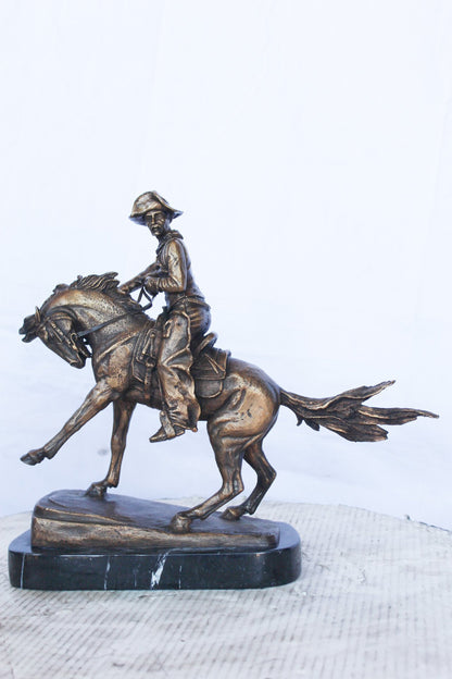 Remington replica Cowboy bronze statue -  Size: 5"L x 15"W x 13"H.