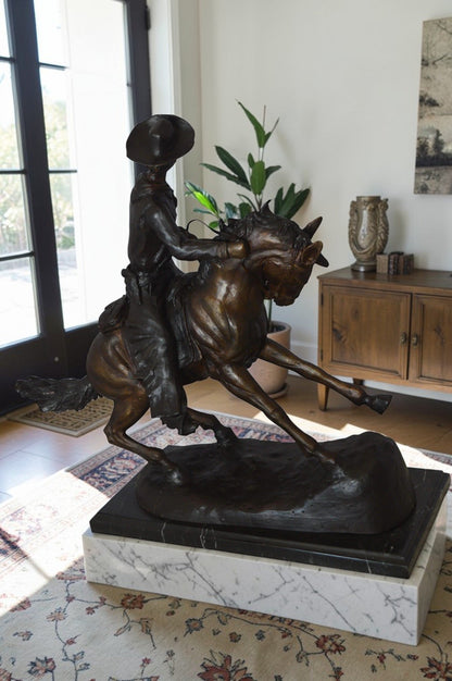 Remington Cowboy on marble Bronze Statue -  Size: 24"L x 9"W x 23"H.