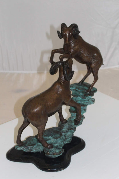 Two Rams on a rock Bronze Statue -  Size: 15"L x 8"W x 16"H.