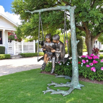 NIFAO Kids on Swing Set Reading a Book Bronze Statue – Rhian Handcrafted Sculpture with Joyful Detail for Gardens, Lawns, or Playful Outdoor Spaces – 50" L x 40" W x 70" H
