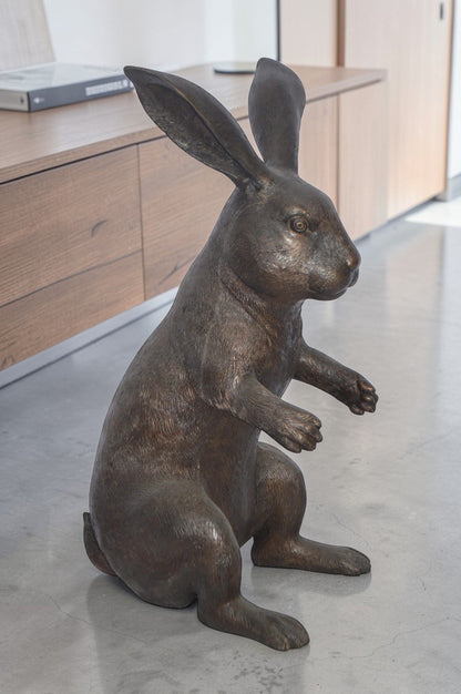 Rabbit looking down bronze statue - Size: 10"L x 12"W x 20"H.