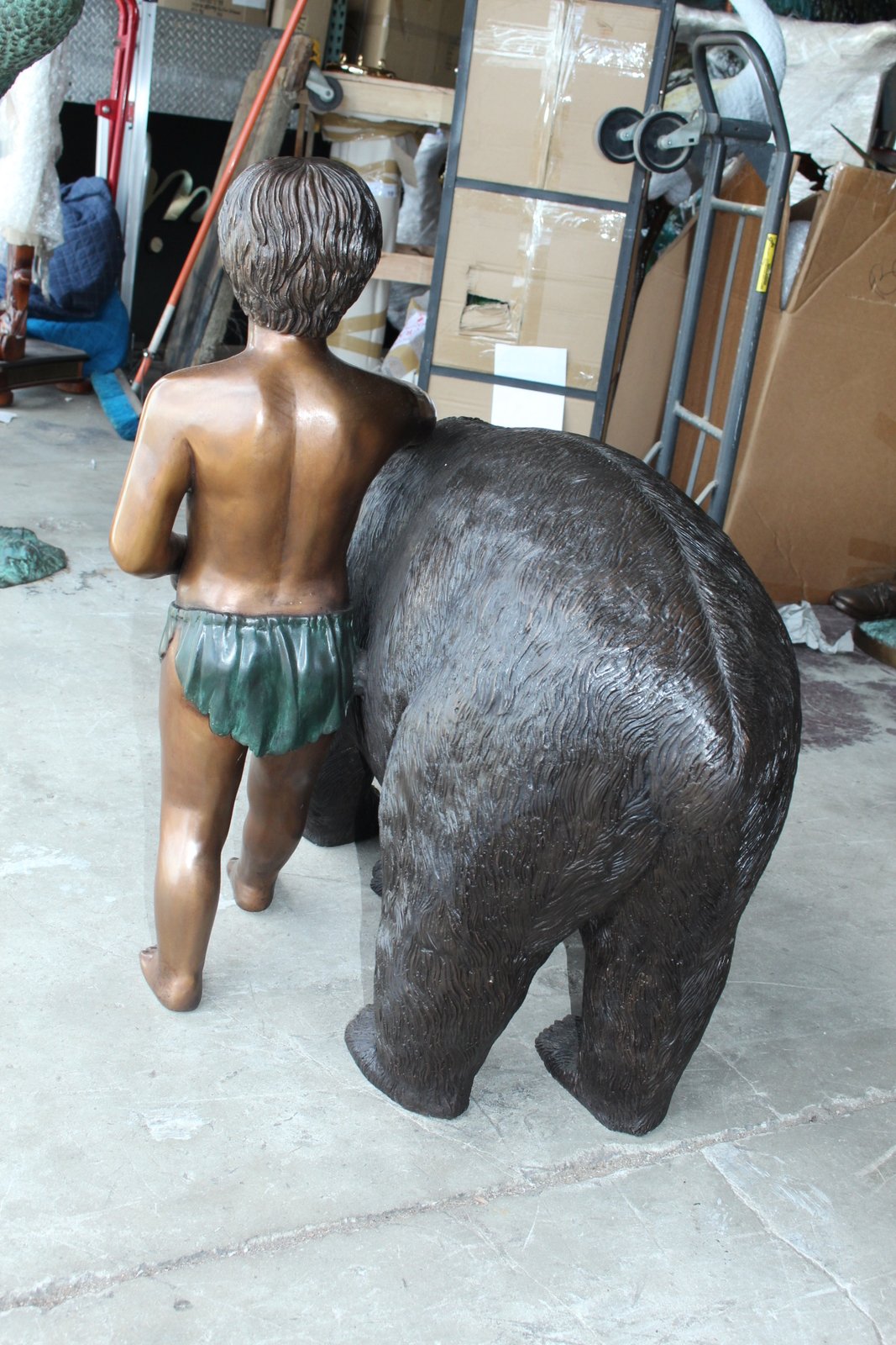 A bear with a boy bronze statue -  Size: 39"L x 24"W x 32"H.