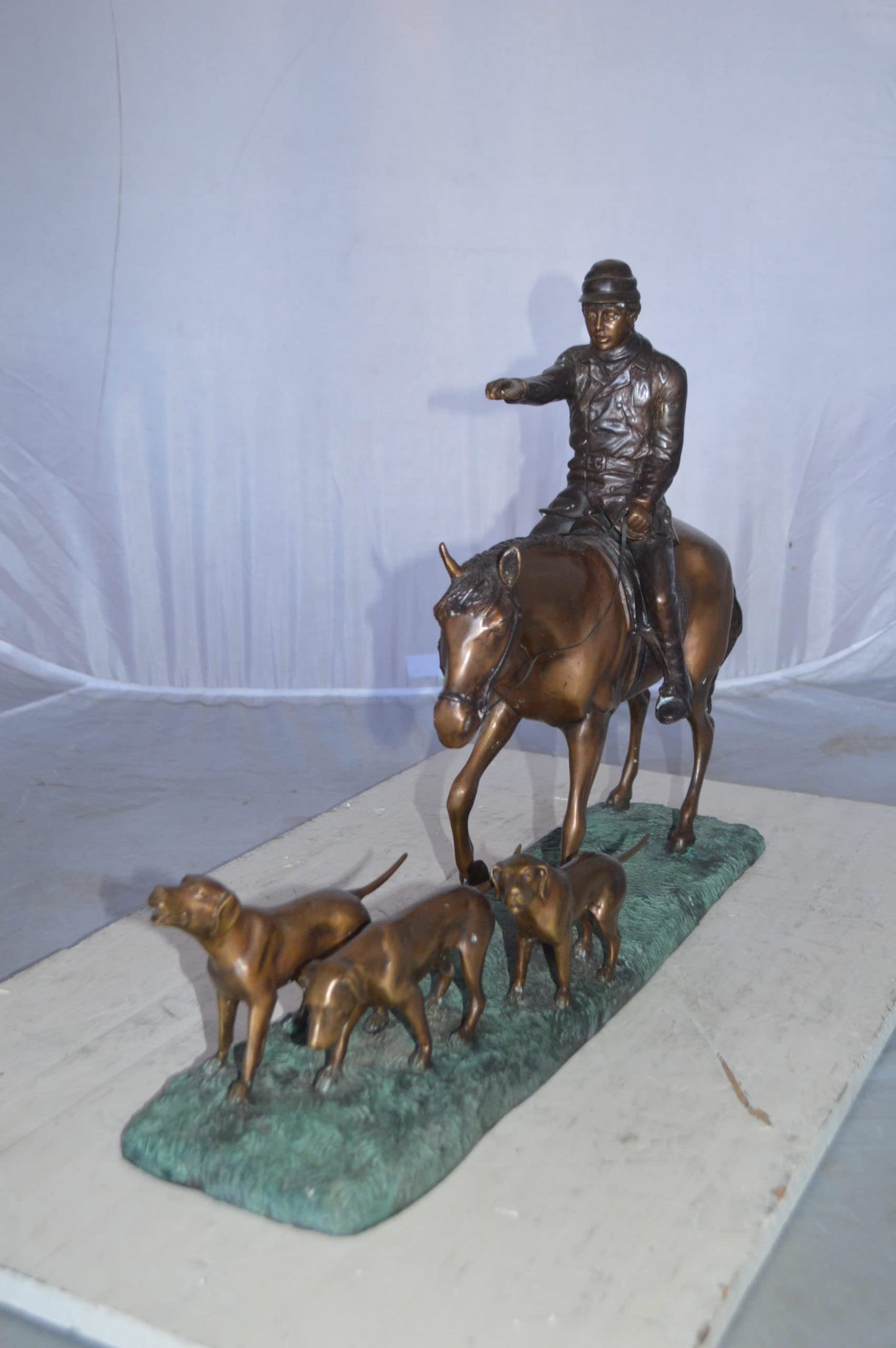 Hunter with three dogs Bronze Statue -  Size: 27"L x 6"W x 18"H.