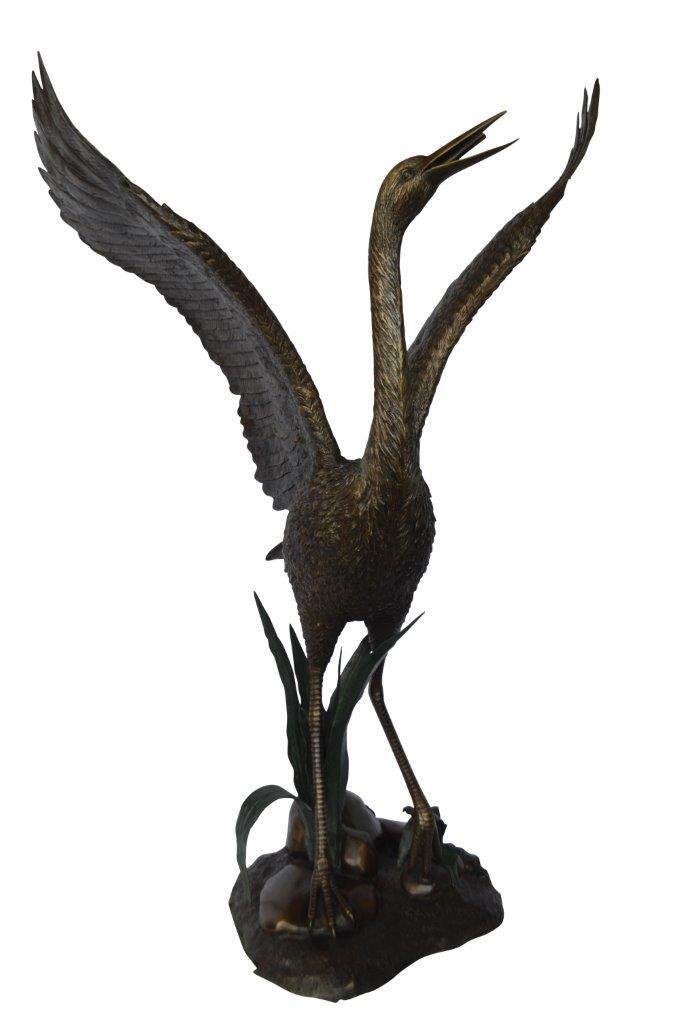 Crane standing on a stone bronze statue -  Size: 28"L x 32"W x 49"H.