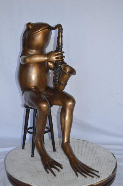 Frog playing saxophone bronze statue - Size: 23"L x 15"W x 30"H.