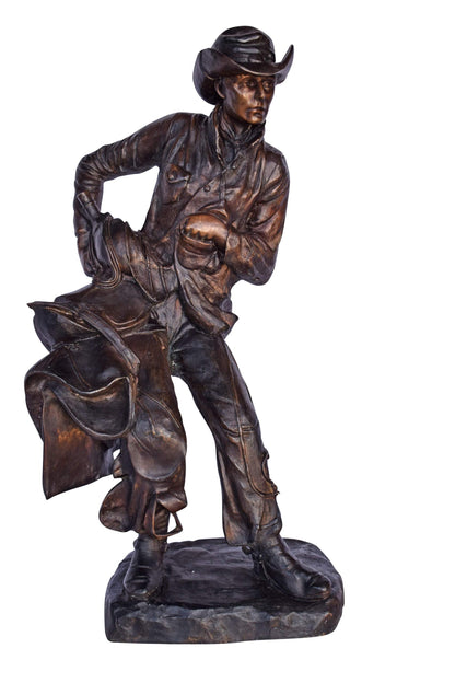 Cowboy Holding His Saddle Bronze Statue - Size: 20"L x 14"W x 35"H.