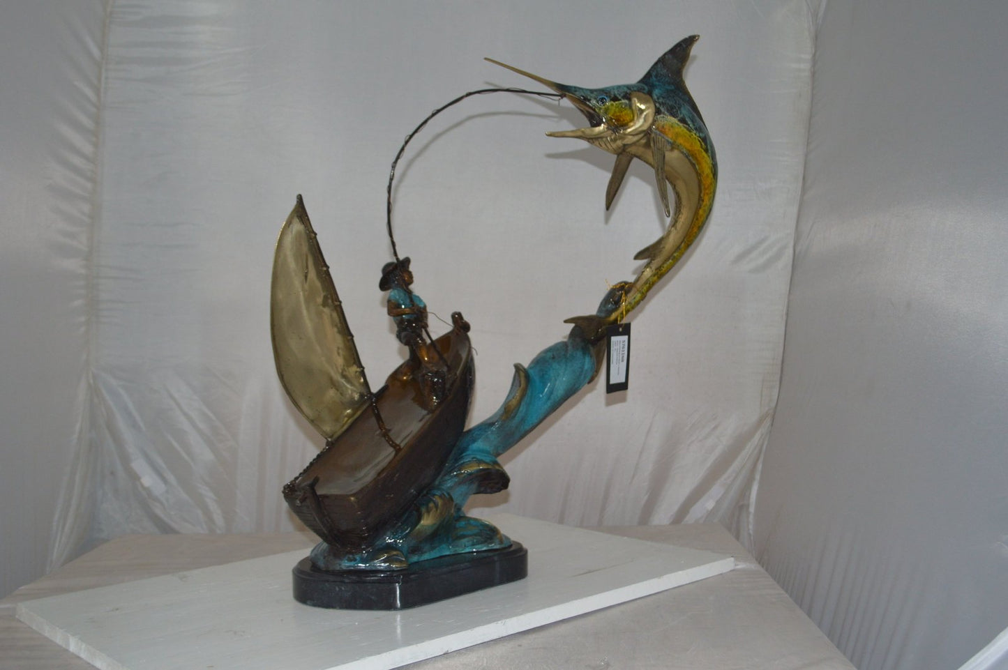 Old Man Fishing a Large Catch Bronze Statue -  Size: 27"L x 13"W x 30"H.