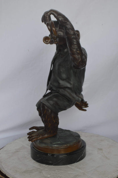 Monkey With Trumpet Bronze Statue - Size: 24"L x 12"W x 26"H.