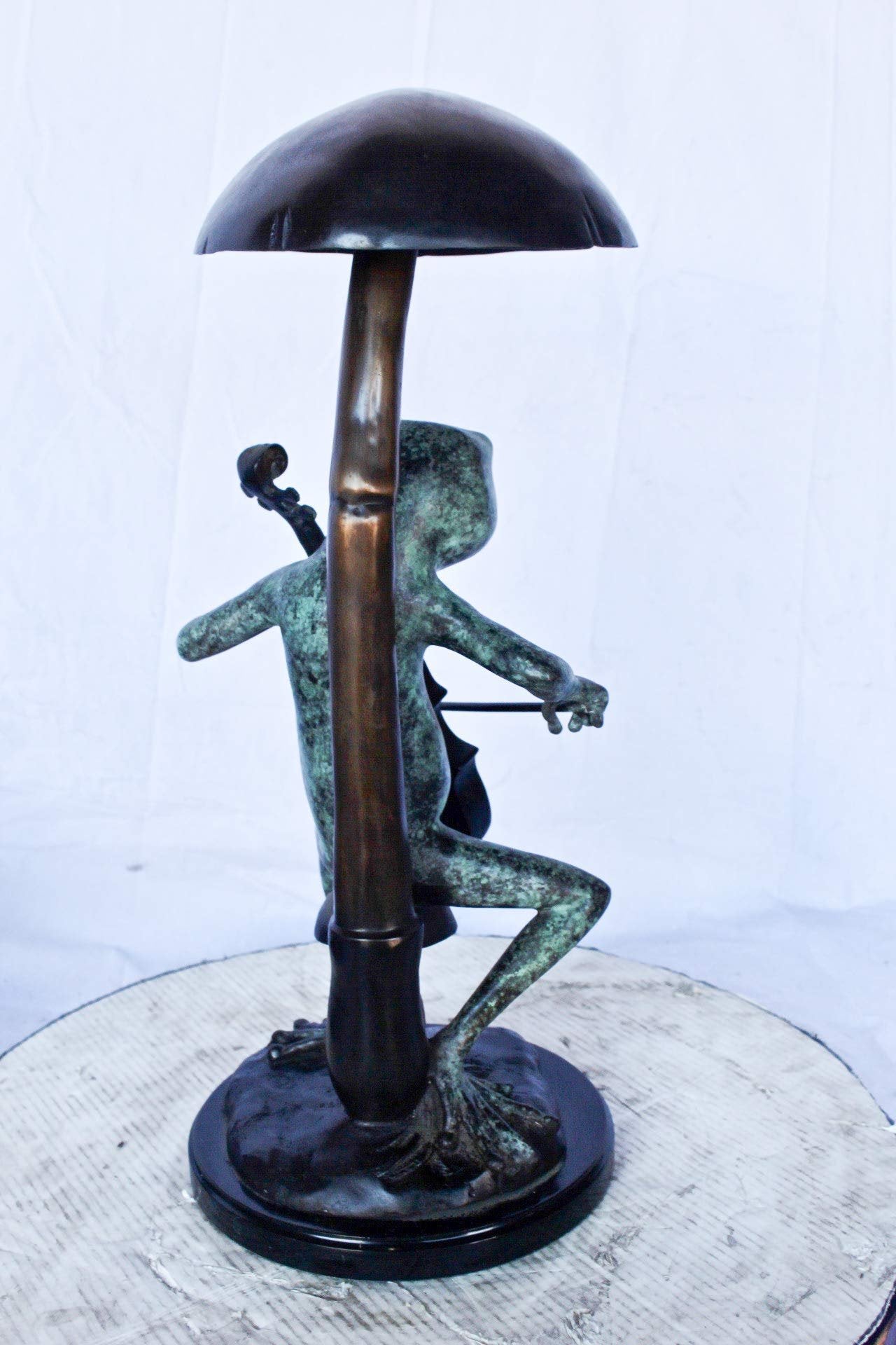 Frog playing cello under mushroom bronze statue -  Size: 10"L x 10"W x 24"H.