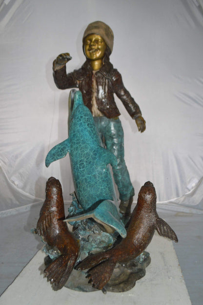 Girl feeding a dolphin and seals bronze fountain -  Size: 28"L x 17"W x 37"H.