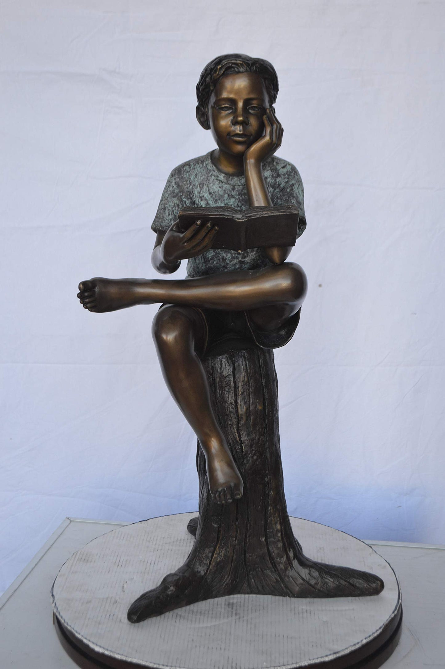 Boy Sitting on a Stump Reading a Book -  Size: 18"L x 20"W x 35"H.