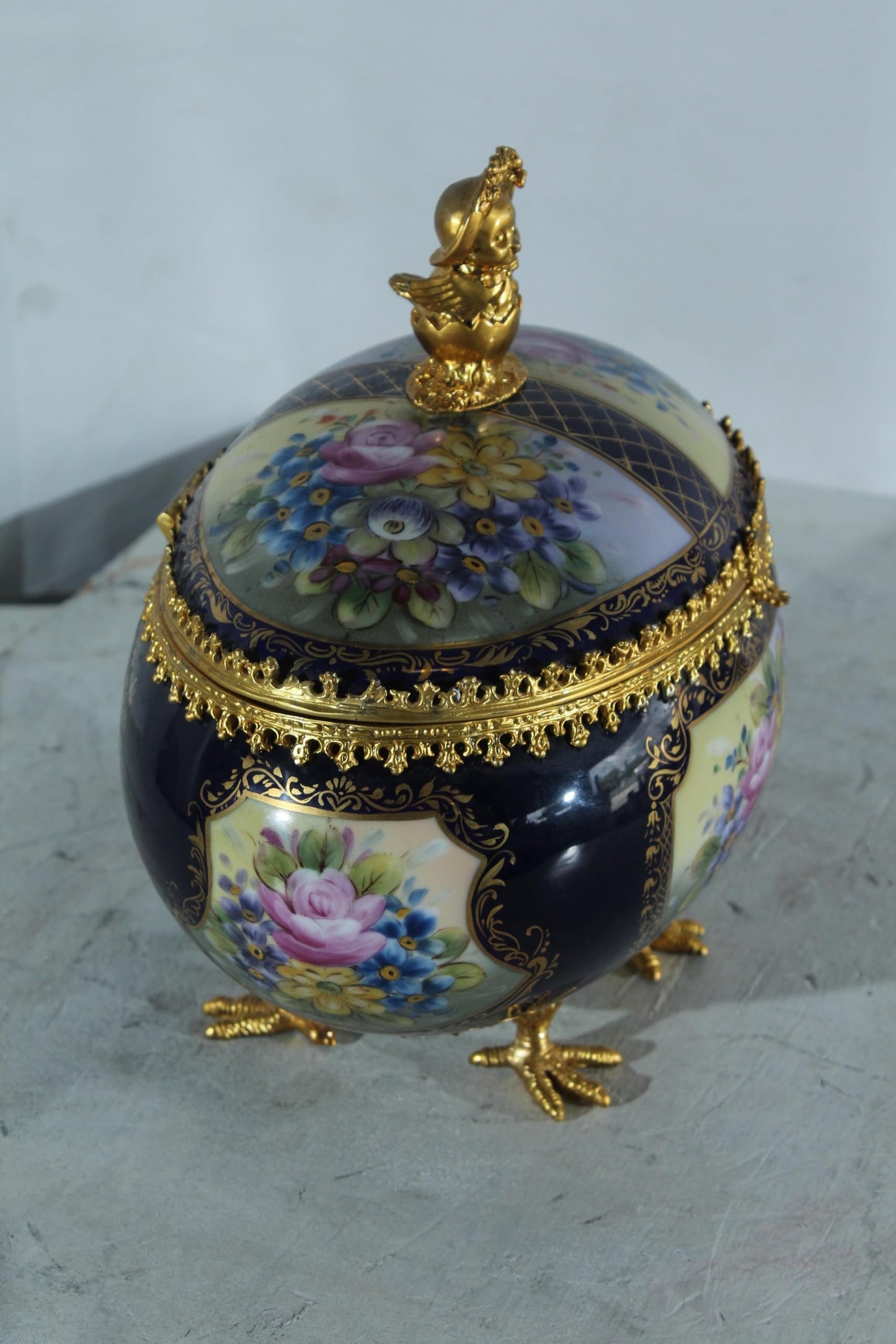 NIFAO Porcelain floral egg shaped lidded box with cherub and chicken feet 11"x8"x12"H