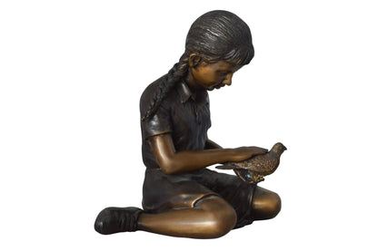 Young seated girl with bird bronze statue - Size: 12"L x 9"W x 14"H.