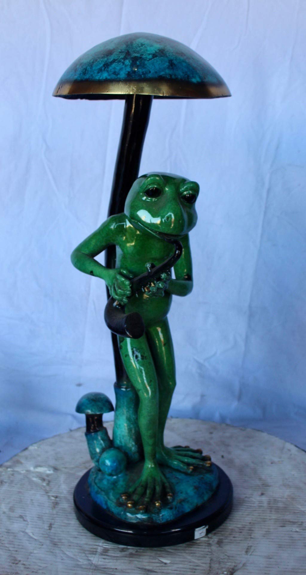 Jazzy frog perched under mushroom bronze statue   -  Size: 10"L x 10"W x 28"H.