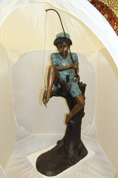 Boy Sitting on a Tree and Fishing Bronze Statue -  Size: 34"L x 28"W x 64"H.