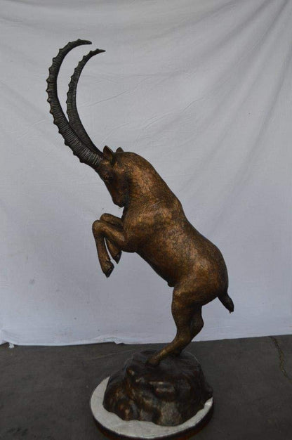 Mountain goat on hind legs bronze statue -  Size: 36"L x 16"W x 66"H.