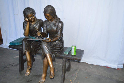 Two Schoolgirls Sitting On a Bench Bronze Statue -  Size: 45"L x 24"W x 41"H.