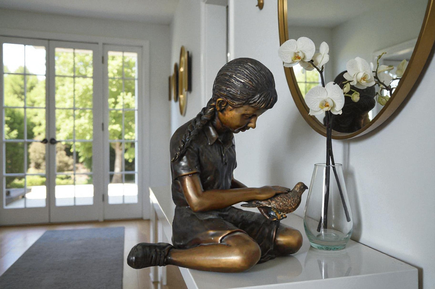 Young seated girl with bird bronze statue - Size: 12"L x 9"W x 14"H.