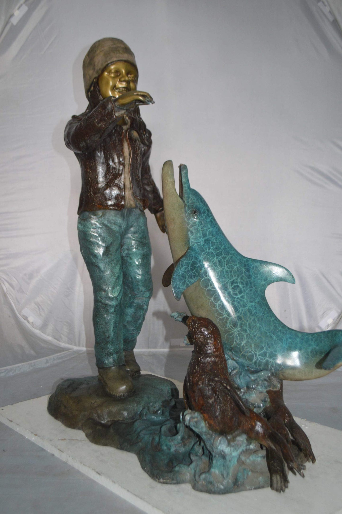 Girl feeding a dolphin and seals bronze fountain -  Size: 28"L x 17"W x 37"H.