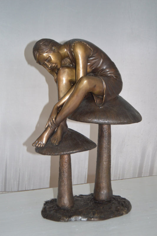 Girl sitting on Mushrooms Bronze Statue -  Size: 13"L x 11"W x 18"H.