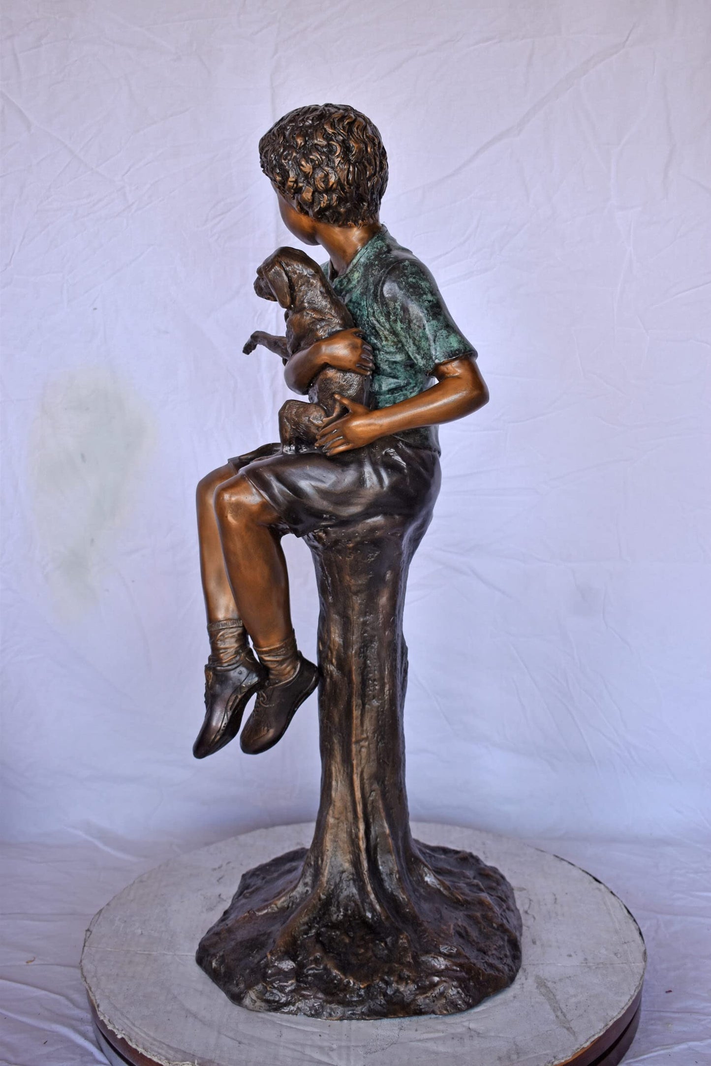 Boy Sitting on A Log with His Puppy Bronze Statue - Size: 15"L x 15"W x 35"H.
