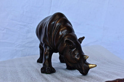 Relaxed Rhino bronze statue -  Size: 16"L x 9"W x 8"H.