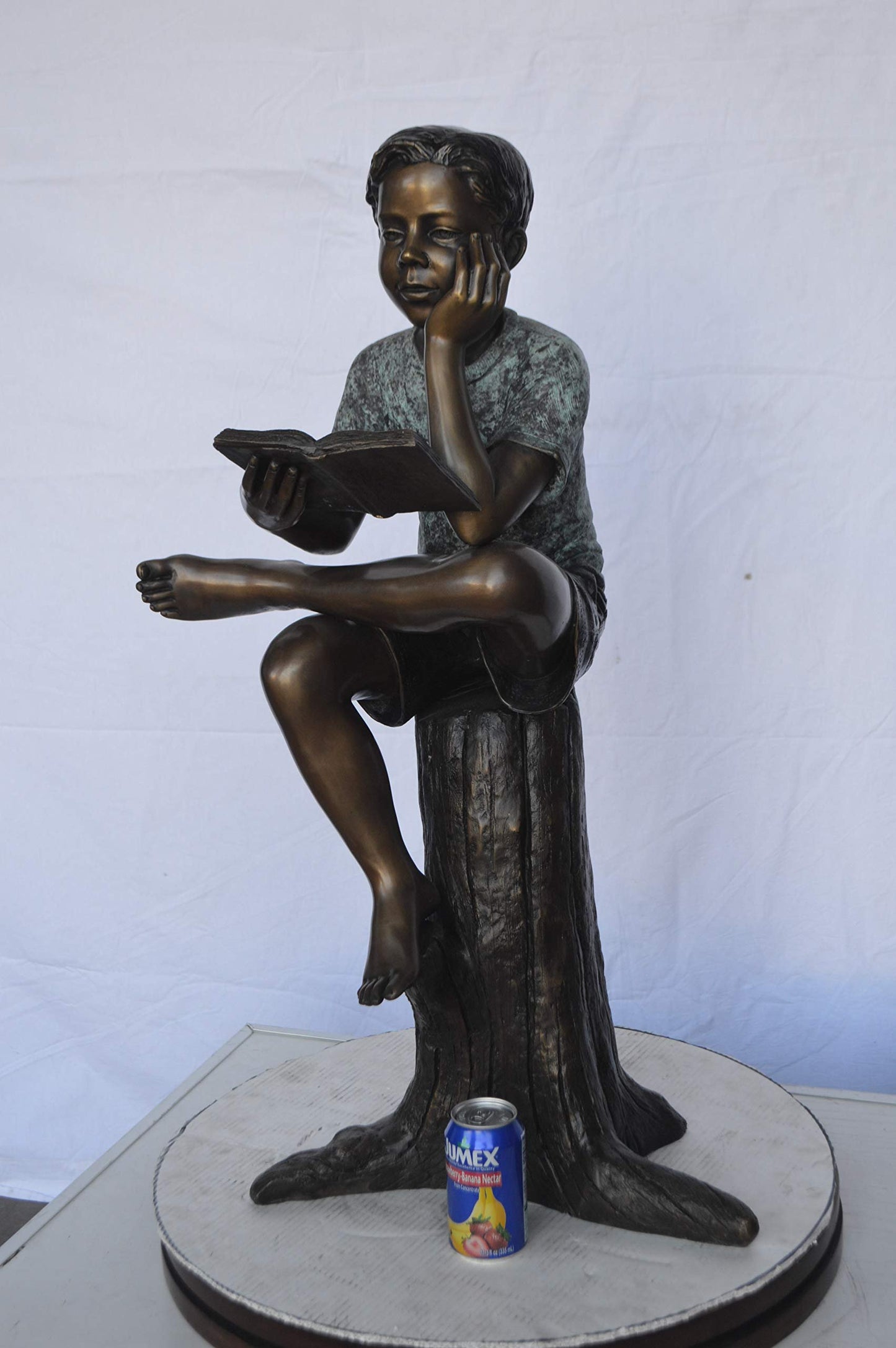 Boy Sitting on a Stump Reading a Book -  Size: 18"L x 20"W x 35"H.
