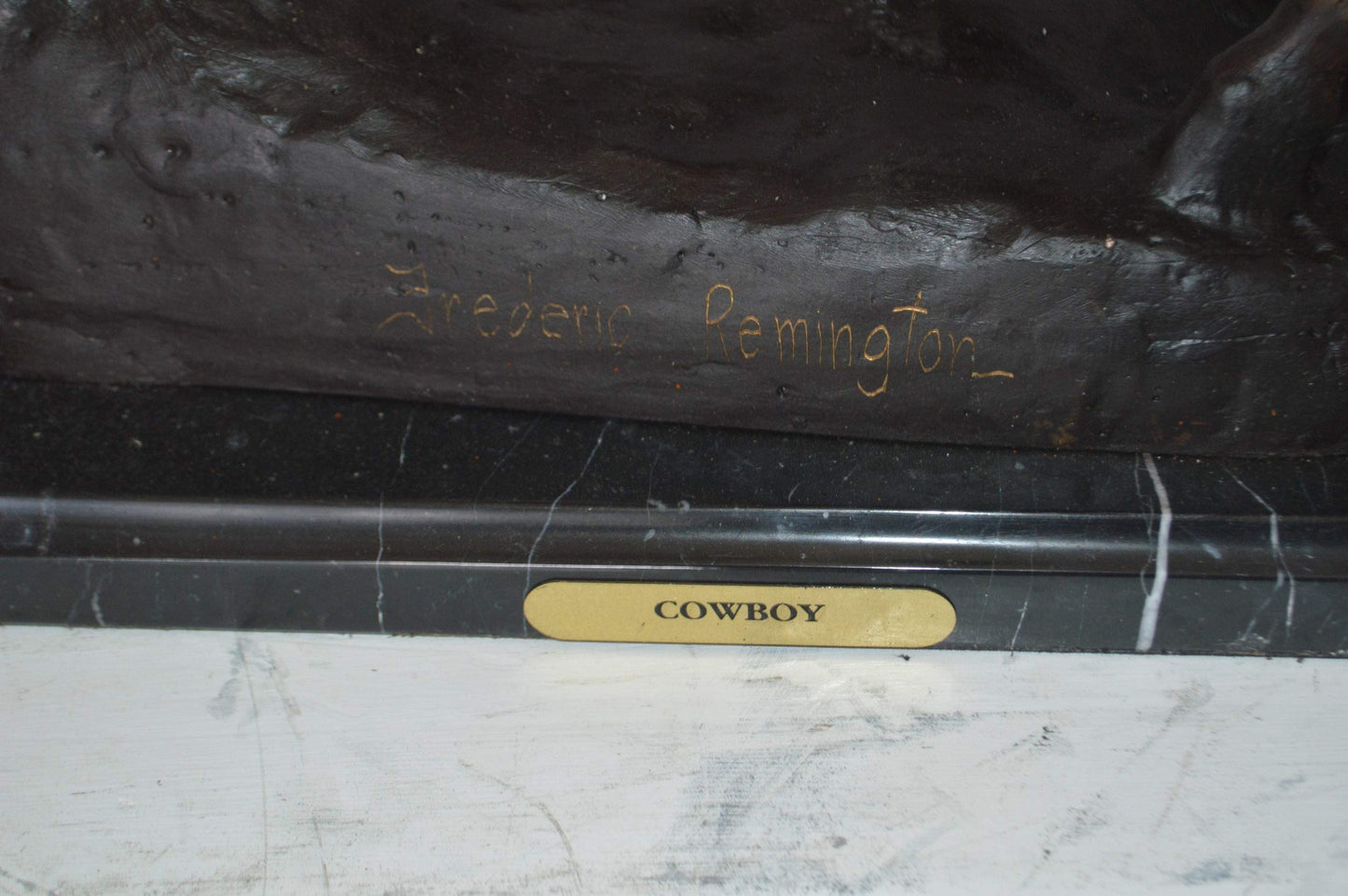 Remington Cowboy on marble Bronze Statue -  Size: 24"L x 9"W x 23"H.