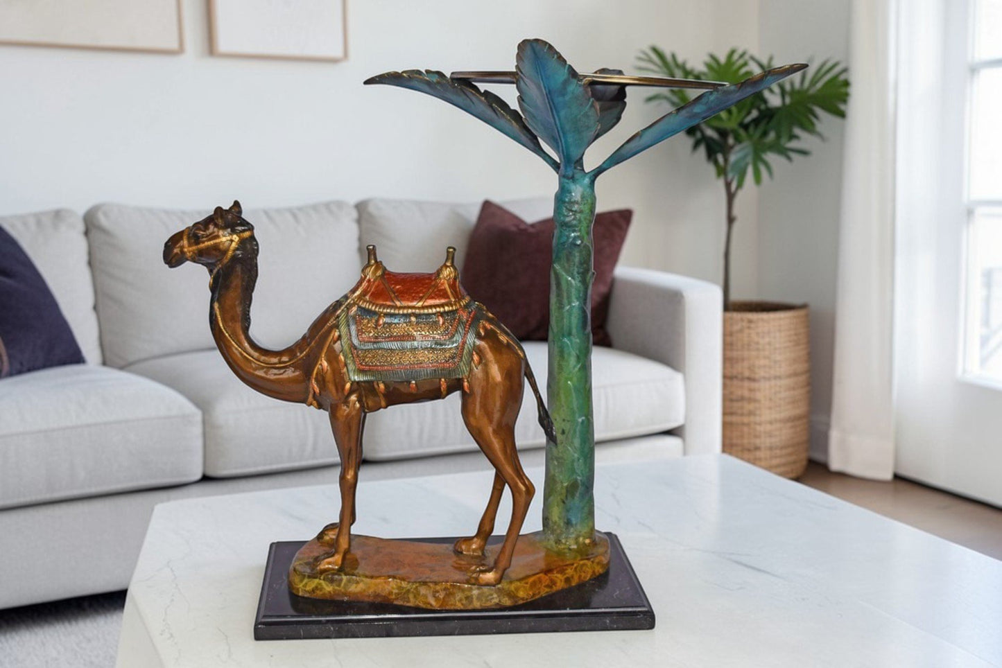 Camel Standing Under A Palm Tree Bronze Statue - Size: 20"L x 29"W x 25"H.