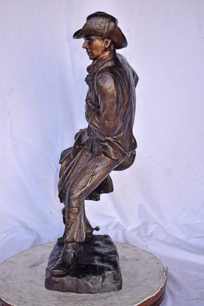 Cowboy Holding His Saddle Bronze Statue - Size: 20"L x 14"W x 35"H.