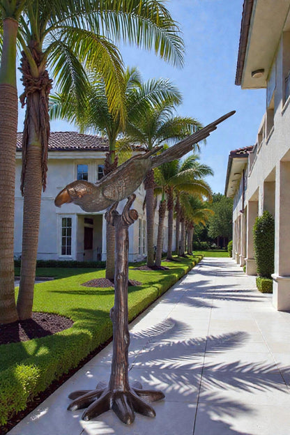Parrot on a Tree looking Down Bronze Statue - Size: 37"L x 15"W x 47"H.