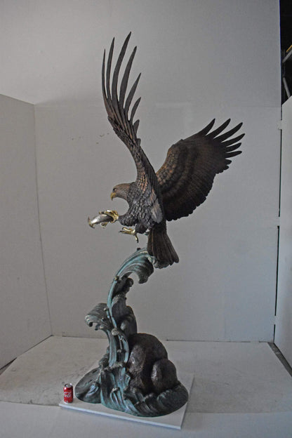 Eagle in Action Catching His Prey Bronze Statue - Size: 68"L x 40"W x 87"H.