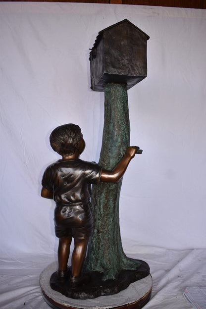 A Boy Standing by His Mailbox Looking at Birds Bronze Statue  25" x 22" x 51"H.