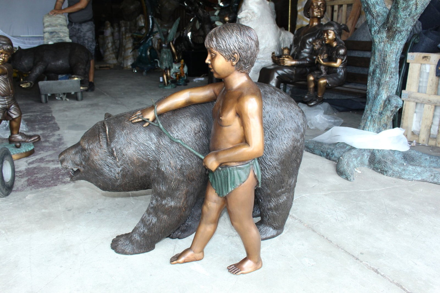 A bear with a boy bronze statue -  Size: 39"L x 24"W x 32"H.